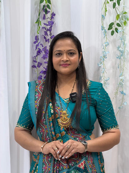 Festive Teal Green Saree with Intricate Traditional Patterns