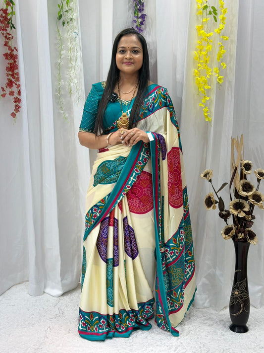 Elegant Cream Printed Saree with Teal Border & Multicolor Traditional Motifs