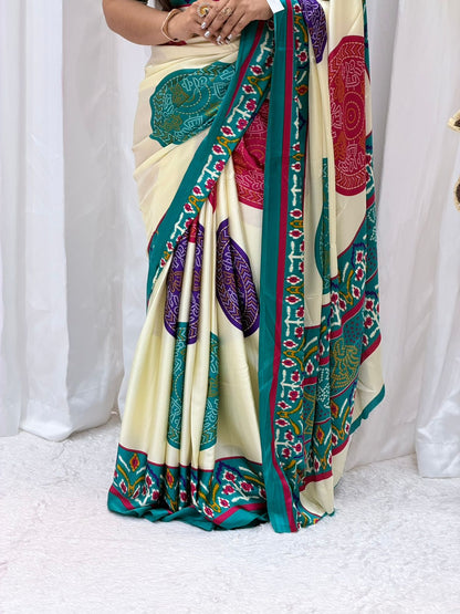 Elegant Cream Printed Saree with Teal Border & Multicolor Traditional Motifs